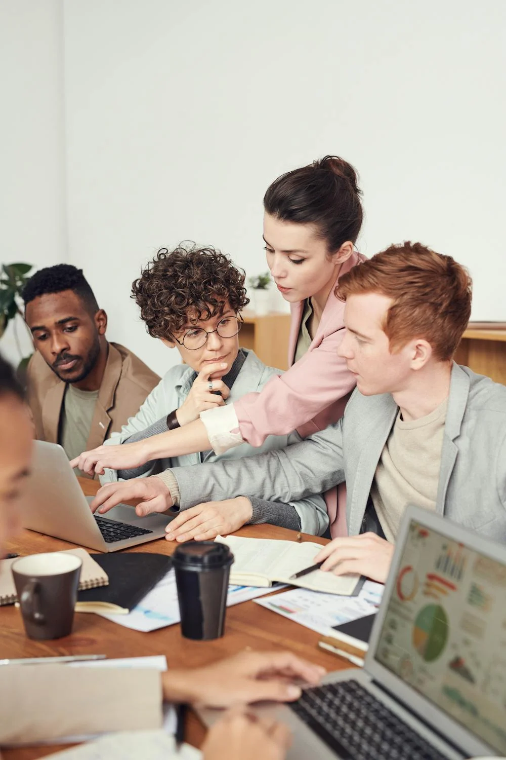 Group of people at a computer collaborating